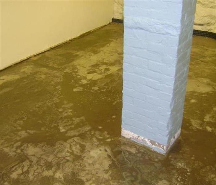 muddy floor, grey column in basement
