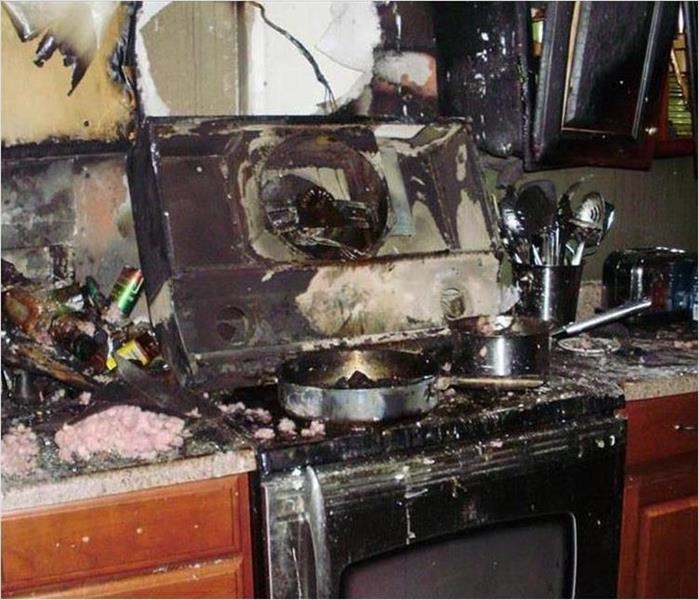 fire destroyed kitchen range and cabinets from a grease fire