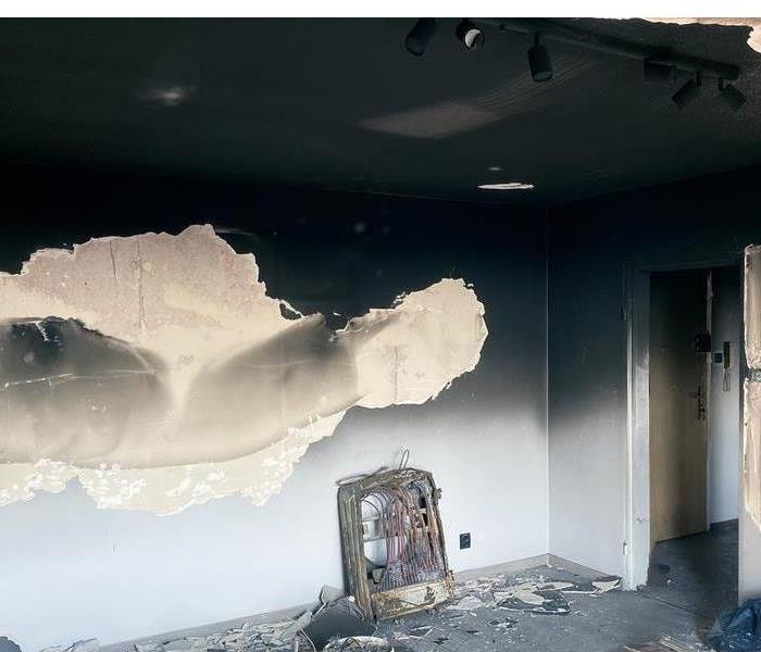 Room after fire damage with a wall covered in soot