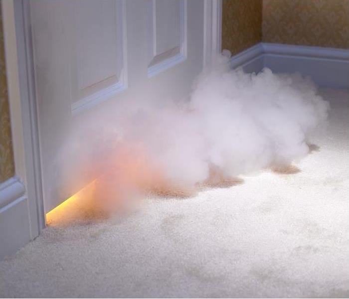 smoke entering room from under door; flame seen